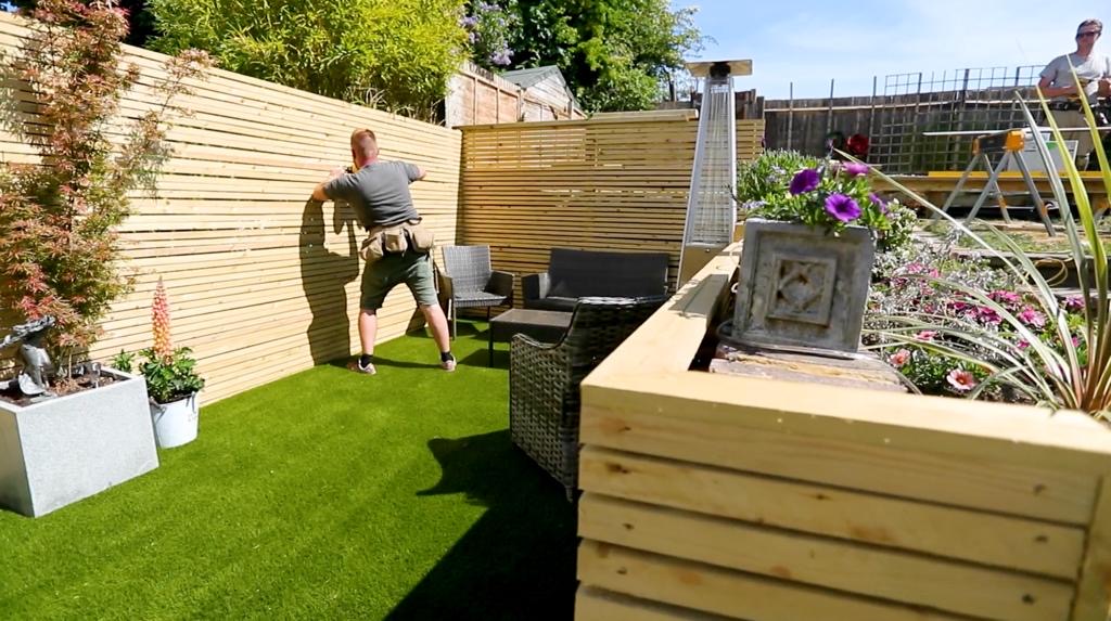 Installation of a cedar slatted fence on a residential garden build