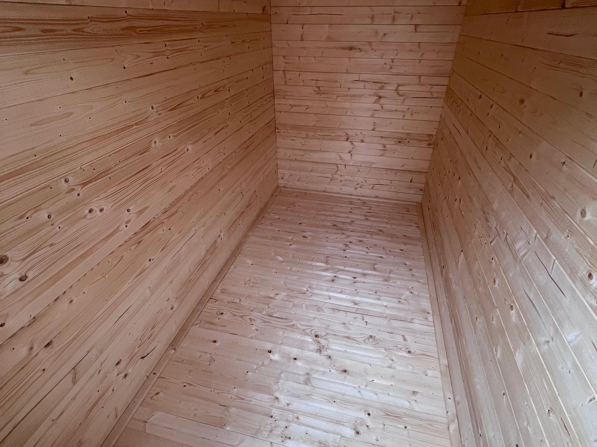 Finished pre-fabricated insulated garden room with double doors and side window in a South Croydon back garden